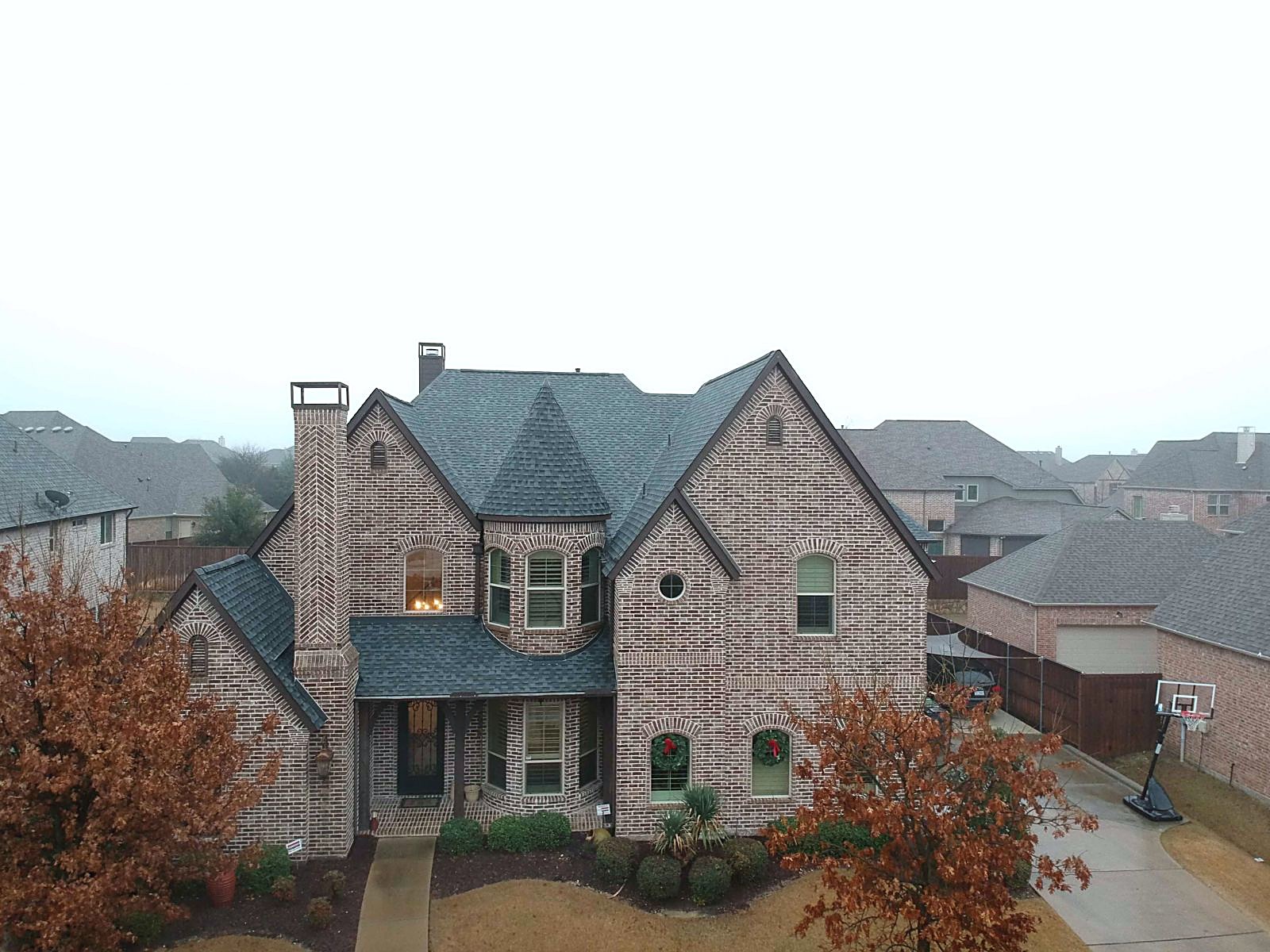 Brick and stone two-story home with a new Pewter shingle roof