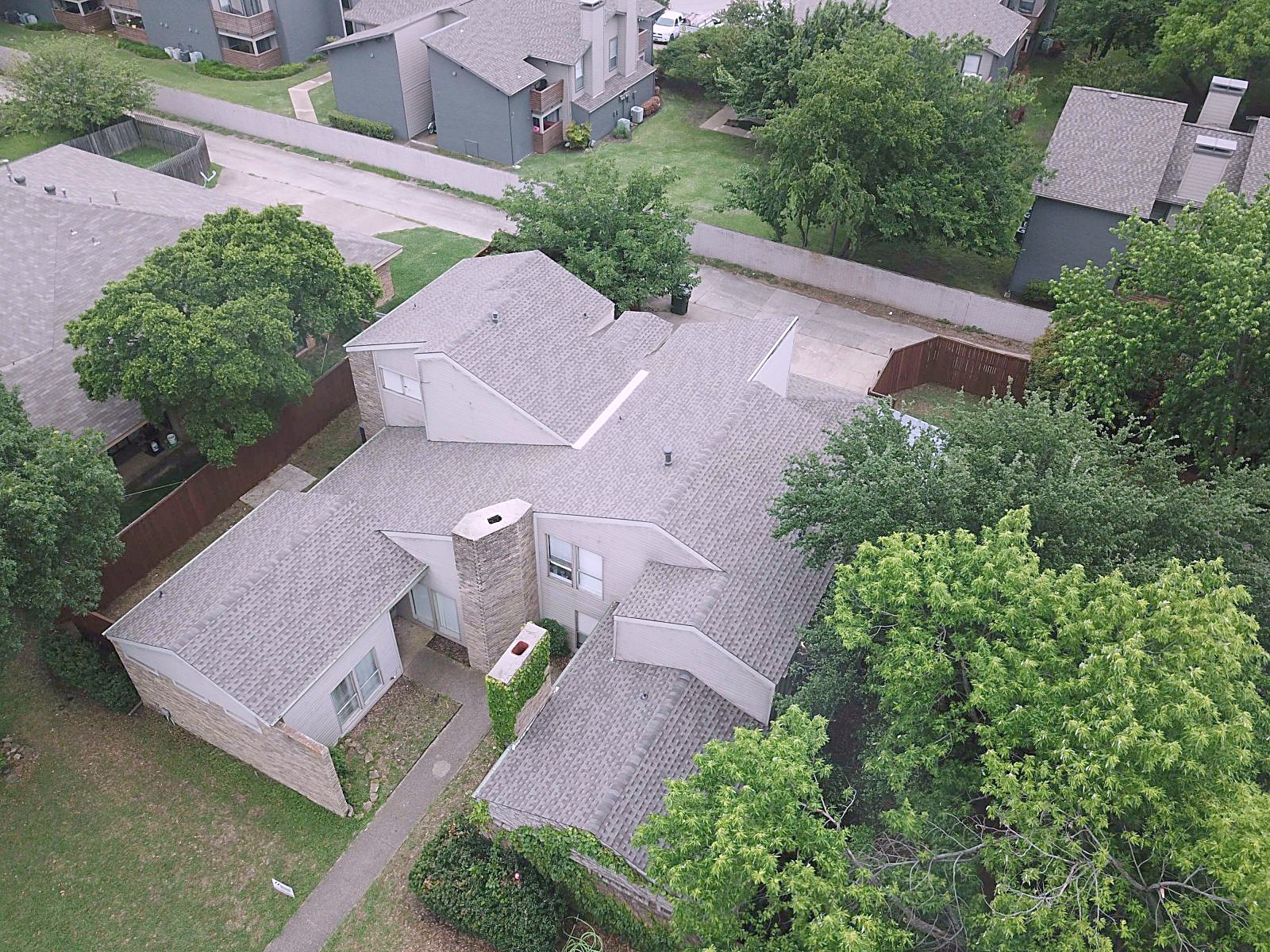 Aerial view of a finished Weatherwood shingle roof on a two-story brick home